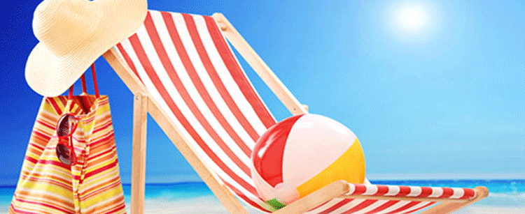 Beach ball on a chair on a beach in the sun